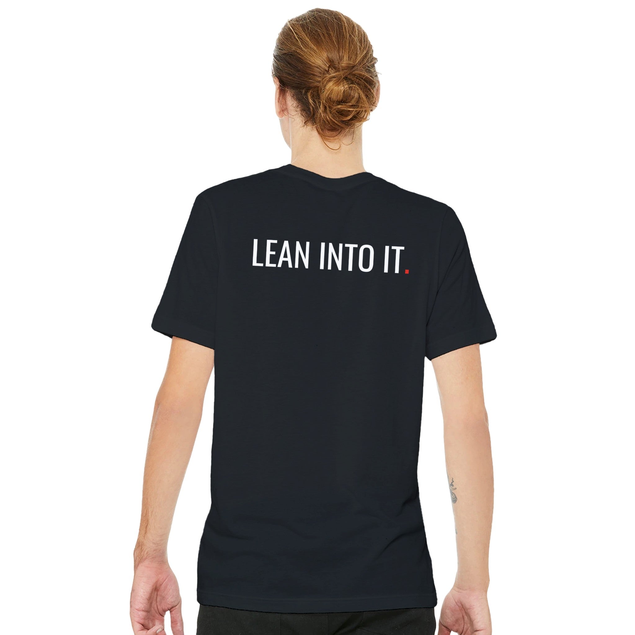 Person wearing a black t-shirt with 'LEAN INTO IT' text on the back, standing against a white background.